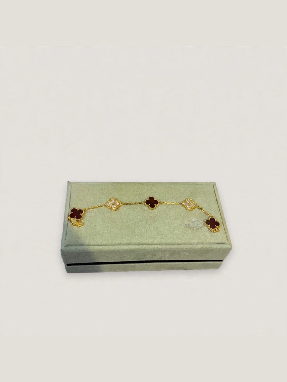 Van Cleef & Arpels Gold Bracelet with Red Clover Motifs and White Accents
